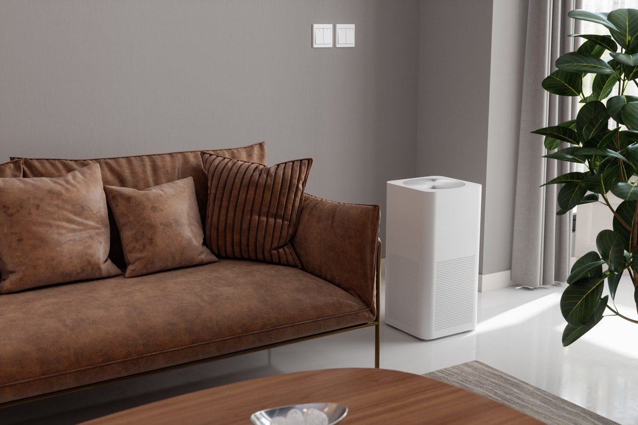 Picture of a living room with an air purifier in the corner.