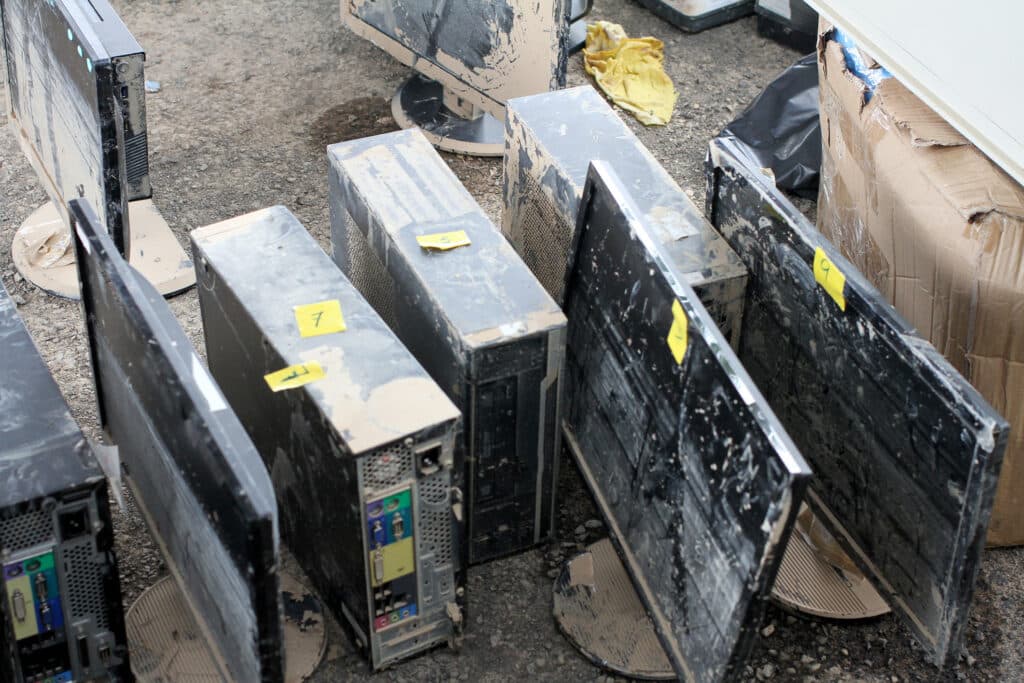 A row of dirty computer monitors, representing the need for content cleaning services after water damage